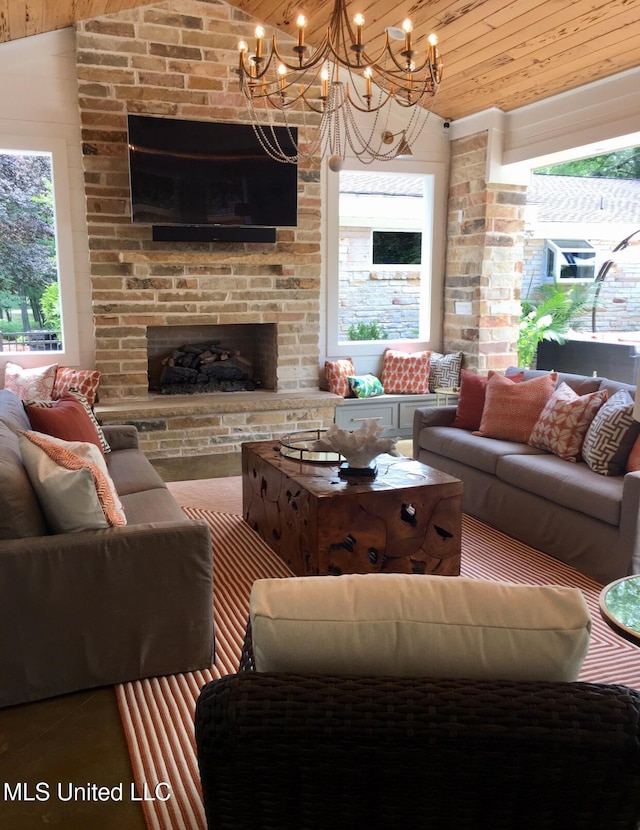 living area with lofted ceiling, wood ceiling, and a large fireplace