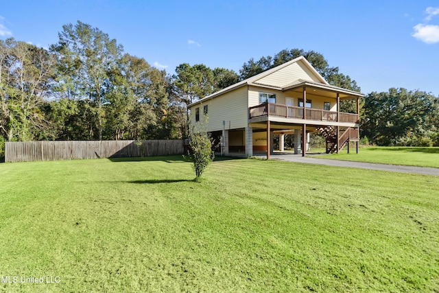 rear view of property with a lawn and a deck