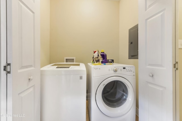 washroom featuring electric panel and washer and clothes dryer