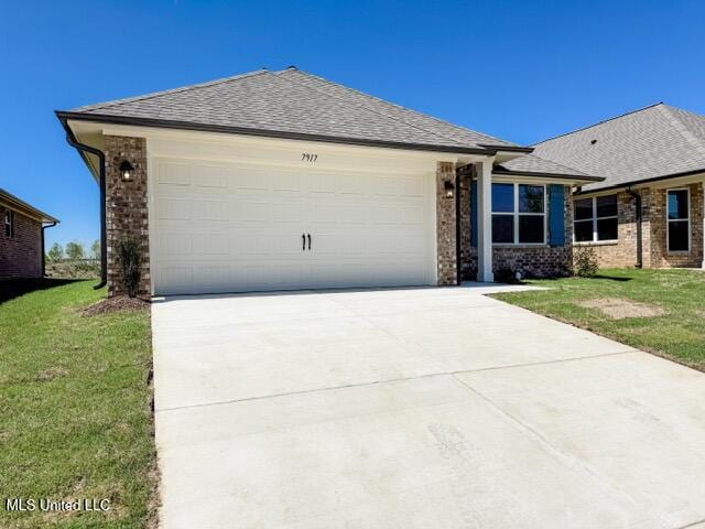 7881 Gardendale Dr, Olive Branch, MS 38654 - single story home featuring an attached garage, concrete driveway, and brick siding