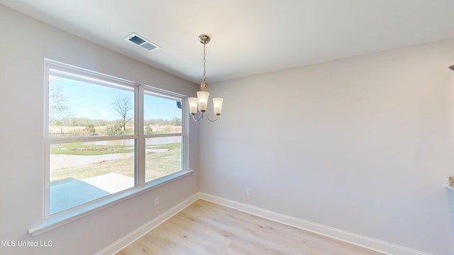 7881 Gardendale Dr, Olive Branch, MS 38654 - spare room featuring a chandelier, light wood-style flooring, and a water view