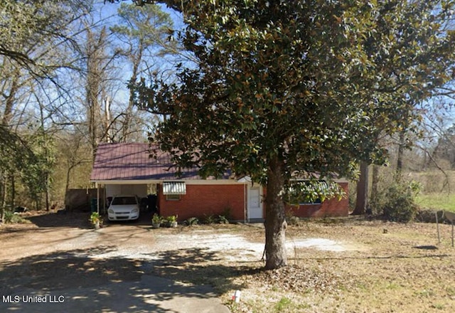 15636 N Jackson St, Durant, MS 39063 - view of front of property with concrete driveway, a carport, and brick siding