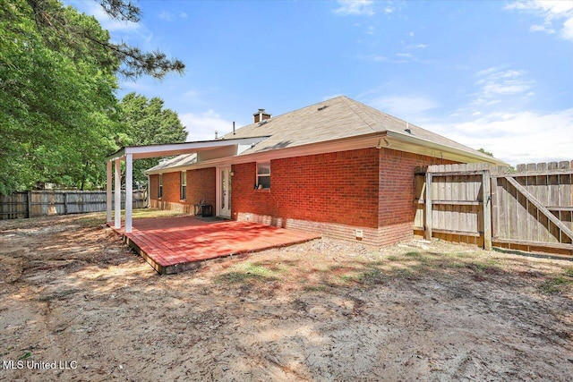 128 Chestnut Dr, Brandon, MS 39047 - rear view of property featuring brick siding, a fenced backyard, and a deck