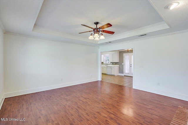 128 Chestnut Dr, Brandon, MS 39047 - unfurnished room featuring a raised ceiling, a ceiling fan, light wood-type flooring, crown molding, and baseboards
