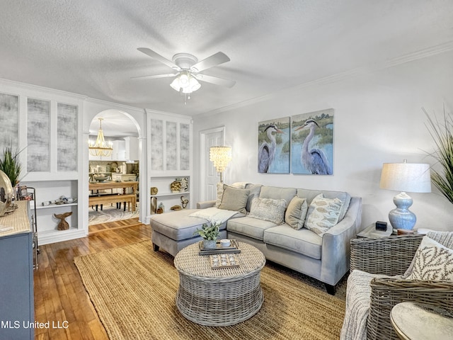 239 Palmetto Ln, Gulfport, MS 39507 - living room with a chandelier, arched walkways, a ceiling fan, crown molding, and hardwood / wood-style flooring