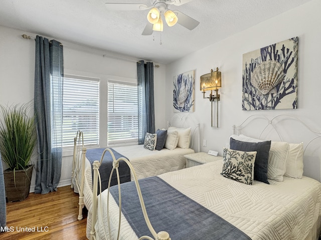 239 Palmetto Ln, Gulfport, MS 39507 - bedroom with wood finished floors, ceiling fan, and baseboards
