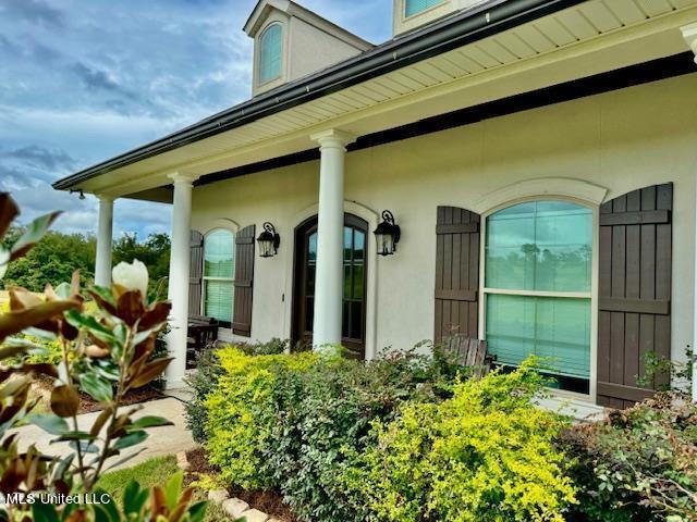 doorway to property featuring a porch