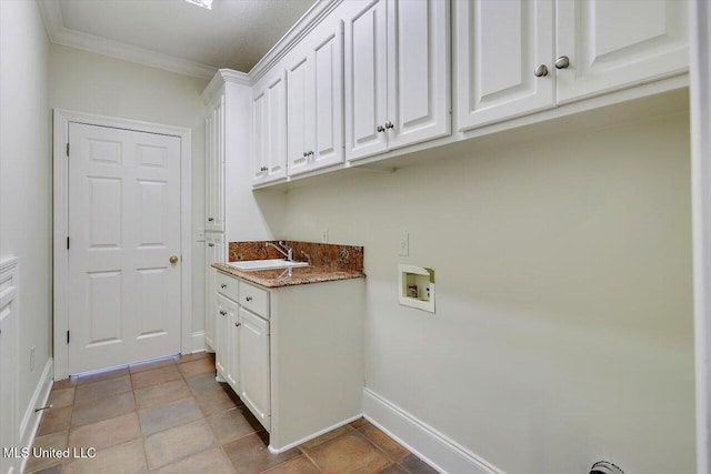 clothes washing area featuring hookup for a washing machine, baseboards, cabinet space, ornamental molding, and a sink