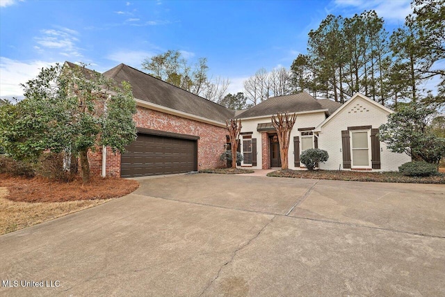 view of front facade featuring brick siding, driveway, and an attached garage