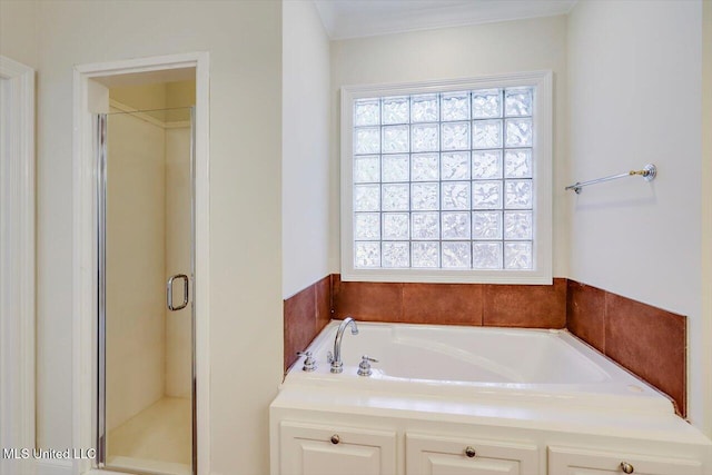 bathroom with a shower stall and a garden tub