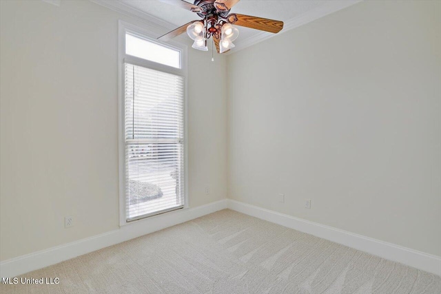 spare room featuring ceiling fan, carpet floors, plenty of natural light, and ornamental molding