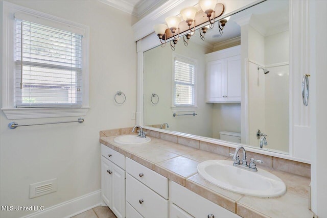 full bathroom with ornamental molding, toilet, and a sink