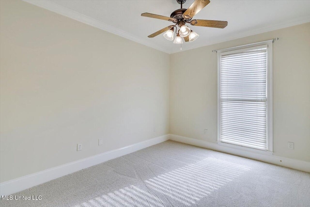 spare room featuring baseboards, carpet floors, ceiling fan, and crown molding