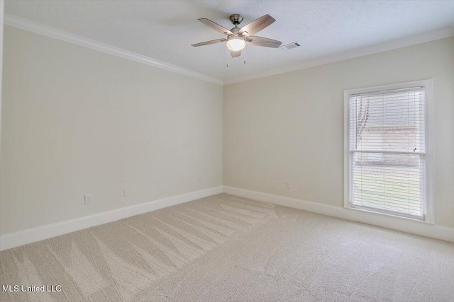 unfurnished room with visible vents, light carpet, a ceiling fan, and crown molding