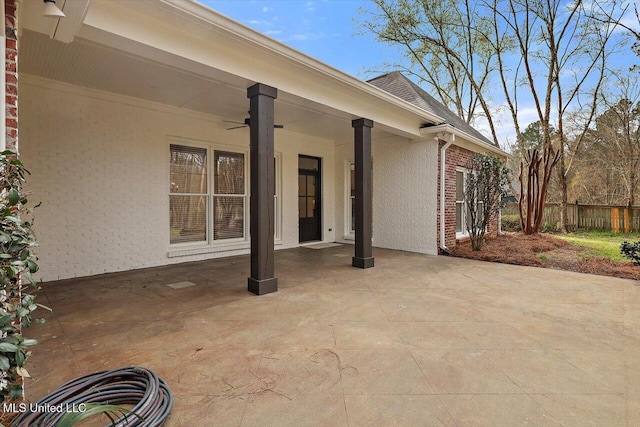 view of patio / terrace with ceiling fan and fence