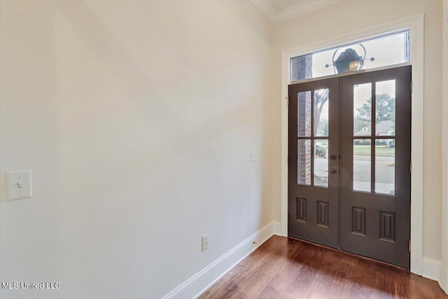 entryway with dark wood-style floors, french doors, crown molding, and baseboards