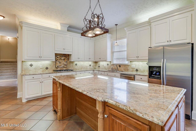 kitchen featuring a sink, tasteful backsplash, appliances with stainless steel finishes, and crown molding