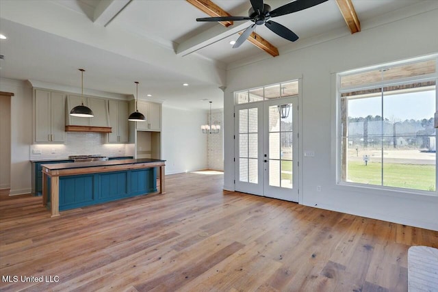 kitchen with beam ceiling, light wood-style flooring, and tasteful backsplash