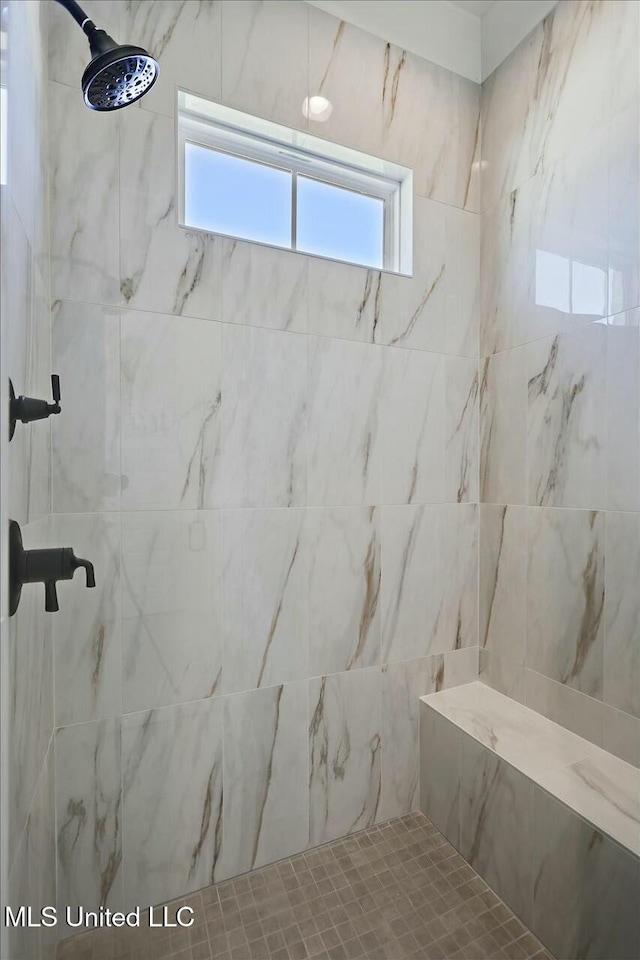 bathroom with a tile shower