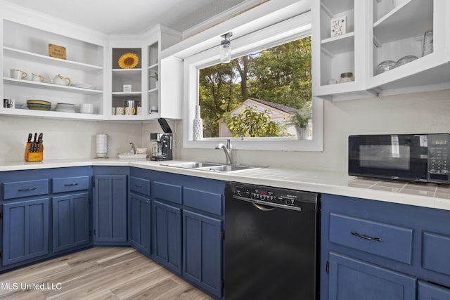 114 Olson Ave, Long Beach, MS 39560 - kitchen with black appliances, blue cabinets, and a sink