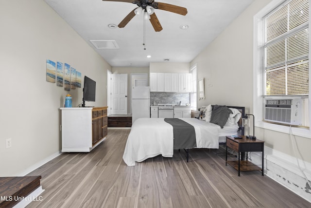 114 Olson Ave, Long Beach, MS 39560 - bedroom with freestanding refrigerator, dark wood-type flooring, baseboards, cooling unit, and recessed lighting