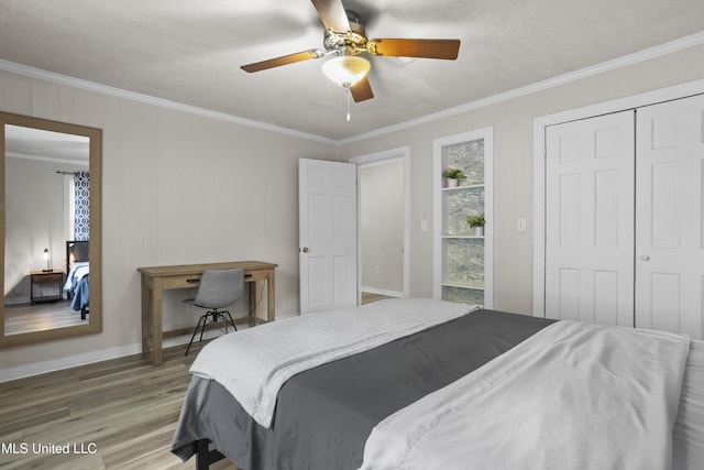 114 Olson Ave, Long Beach, MS 39560 - bedroom with wood finished floors, crown molding, multiple windows, a ceiling fan, and a closet