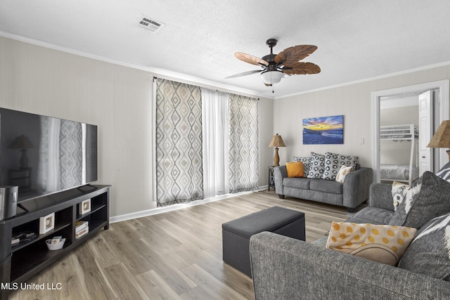 114 Olson Ave, Long Beach, MS 39560 - living room featuring crown molding, wood finished floors, a ceiling fan, baseboards, and a textured ceiling