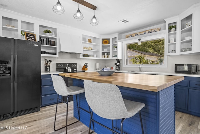 114 Olson Ave, Long Beach, MS 39560 - kitchen featuring wooden counters, black appliances, open shelves, blue cabinetry, and built in desk