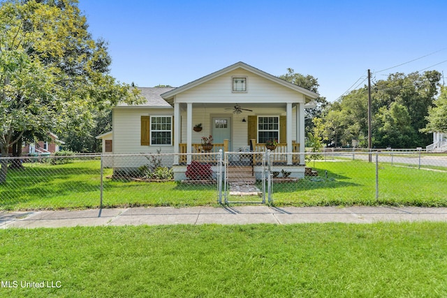 bungalow-style home with covered porch, a front lawn, and ceiling fan