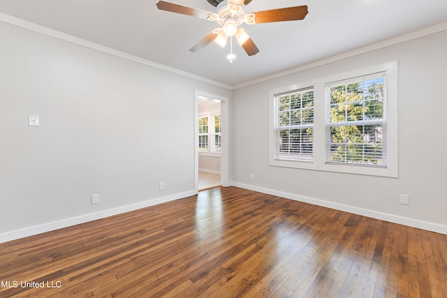 empty room featuring dark wood-type flooring, crown molding, and ceiling fan