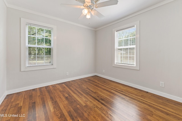 empty room featuring ornamental molding, plenty of natural light, and hardwood / wood-style floors