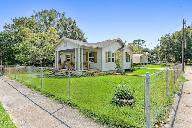 view of front of house with a front yard and covered porch