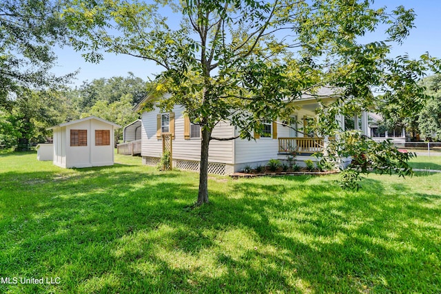 view of yard featuring covered porch and a shed