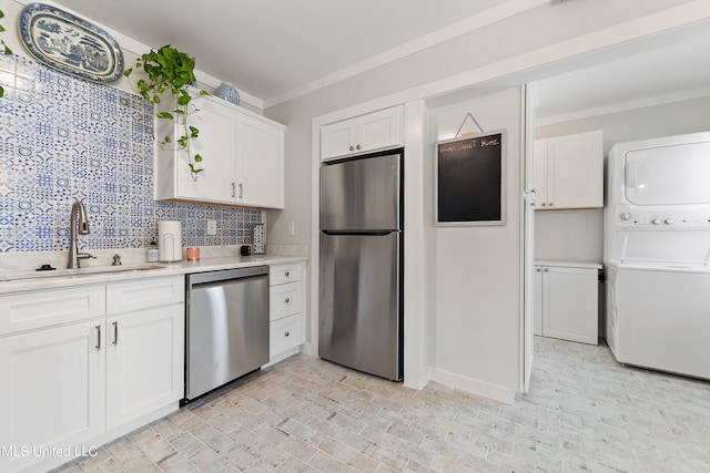 kitchen with sink, white cabinets, stainless steel appliances, and tasteful backsplash