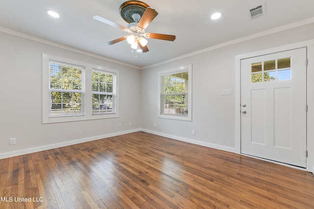 foyer entrance with ornamental molding, hardwood / wood-style flooring, and ceiling fan