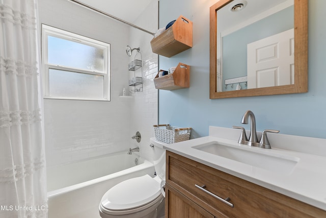 full bathroom with vanity, shower / tub combo with curtain, and toilet