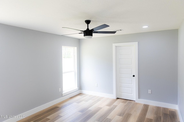 empty room with light wood finished floors, a ceiling fan, baseboards, and recessed lighting