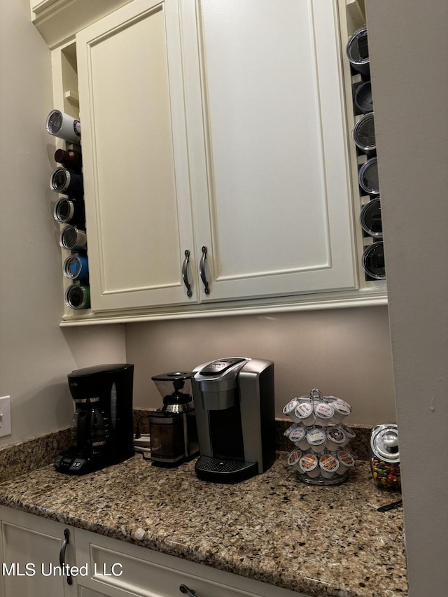 kitchen featuring white cabinetry and stone countertops