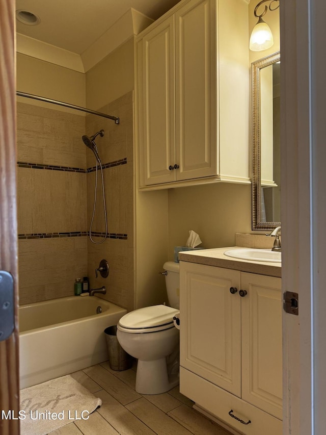 full bathroom with vanity, tile patterned flooring, tiled shower / bath combo, and toilet