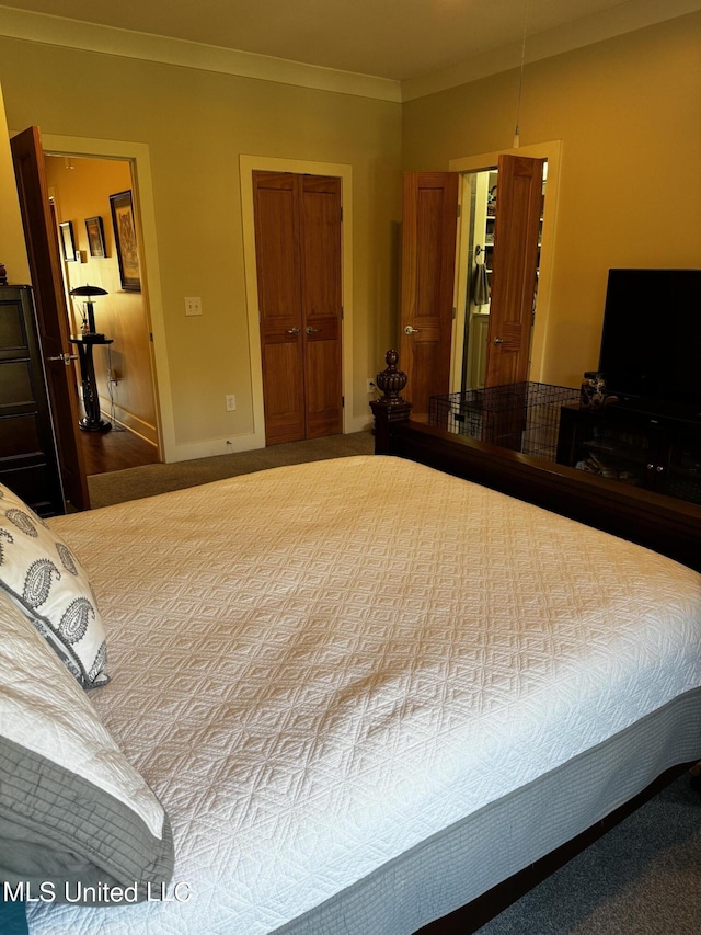 bedroom with ornamental molding and a closet