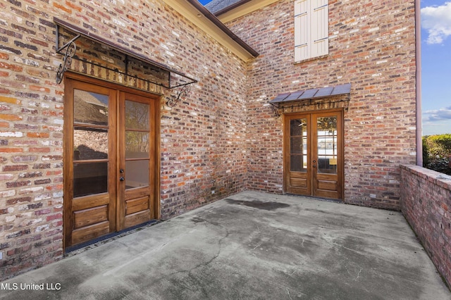 entrance to property with french doors and a patio area