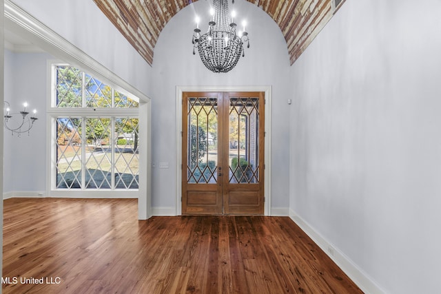 entryway featuring dark hardwood / wood-style flooring, french doors, and a towering ceiling