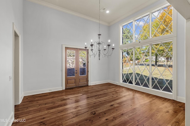 unfurnished dining area with dark hardwood / wood-style flooring, ornamental molding, and a high ceiling