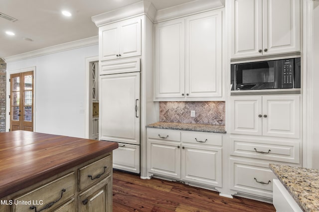 kitchen with french doors, built in appliances, white cabinetry, and dark stone counters