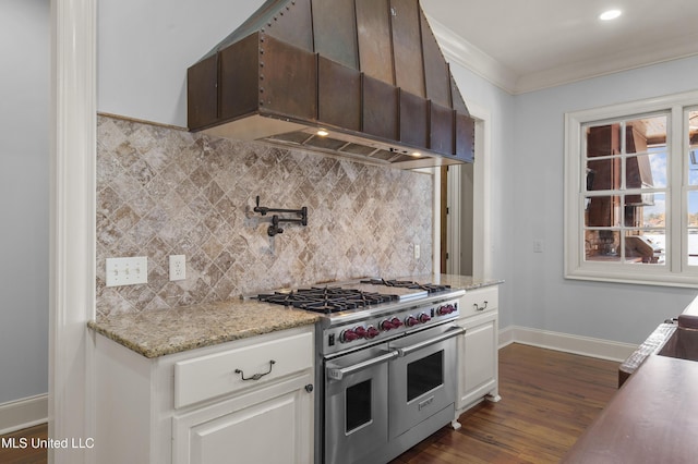 kitchen with double oven range, backsplash, premium range hood, white cabinets, and dark hardwood / wood-style flooring