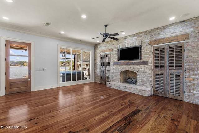 unfurnished living room with dark hardwood / wood-style flooring, ceiling fan, and a healthy amount of sunlight