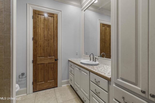 bathroom with tile patterned flooring, vanity, and toilet