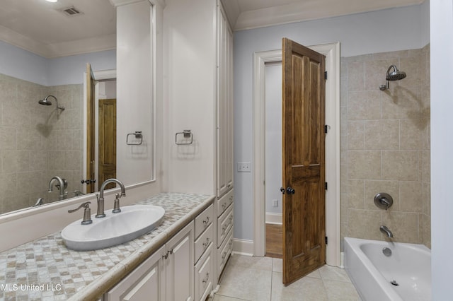 bathroom featuring vanity, tile patterned floors, and tiled shower / bath