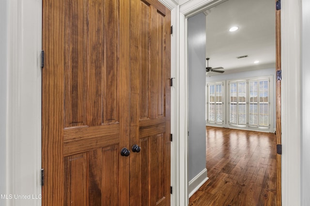 corridor featuring crown molding and wood-type flooring