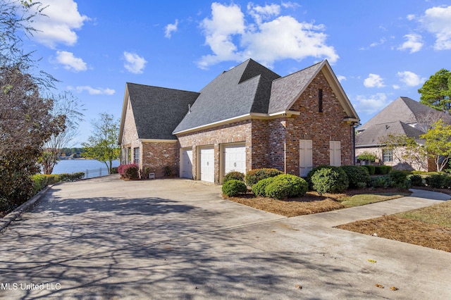 view of side of property with a water view and a garage